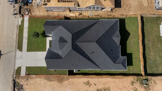 a aerial view of a house with a yard