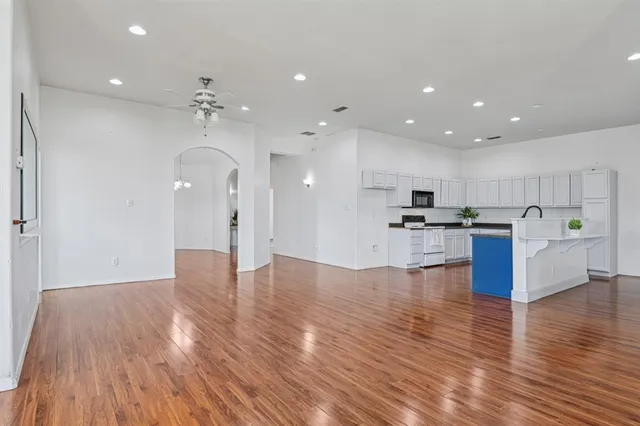 a view of kitchen with cabinets appliances and wooden floor