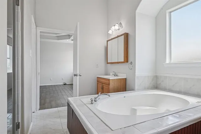 a white bath tub sitting next to a white sink