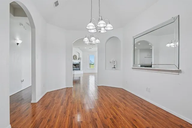 a view of livingroom with hallway and wooden floor