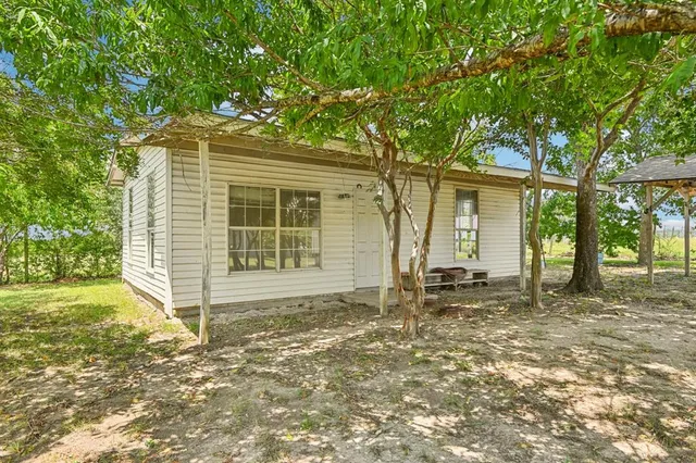 a house with trees in the background
