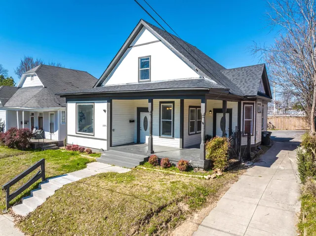 a view of a house with backyard sitting area and garden