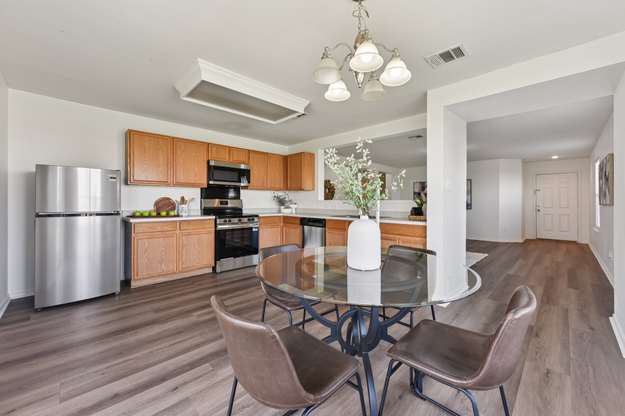Dining space with dark wood finished floors and a chandelier