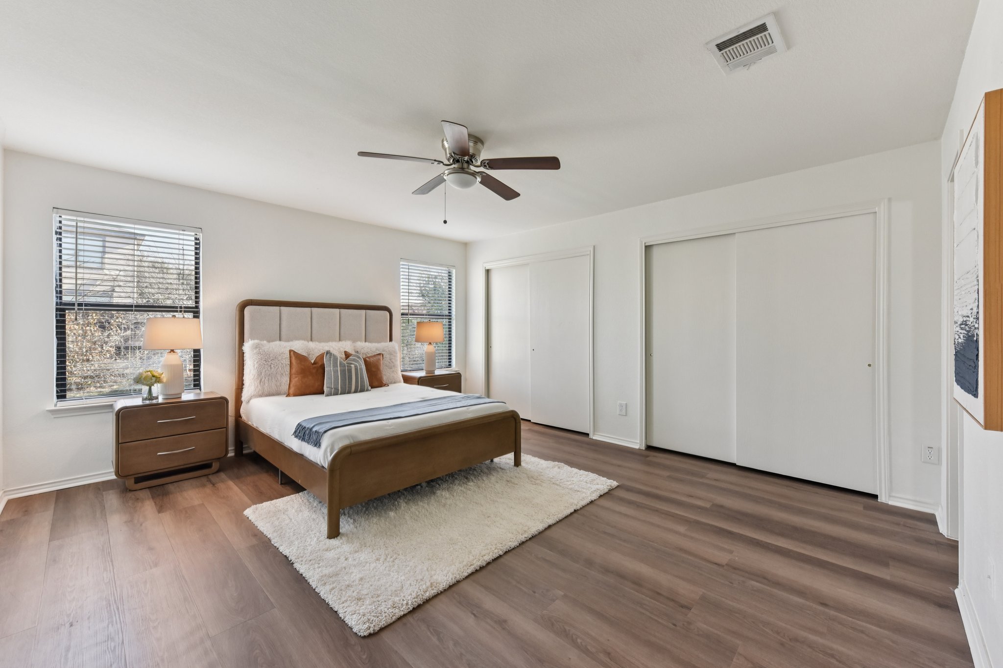 101 Bandara Woods Boulevard Elgin, TX 78621 - Photo 22 of 30 Bedroom featuring two closets, dark wood finished floors, and ceiling fan