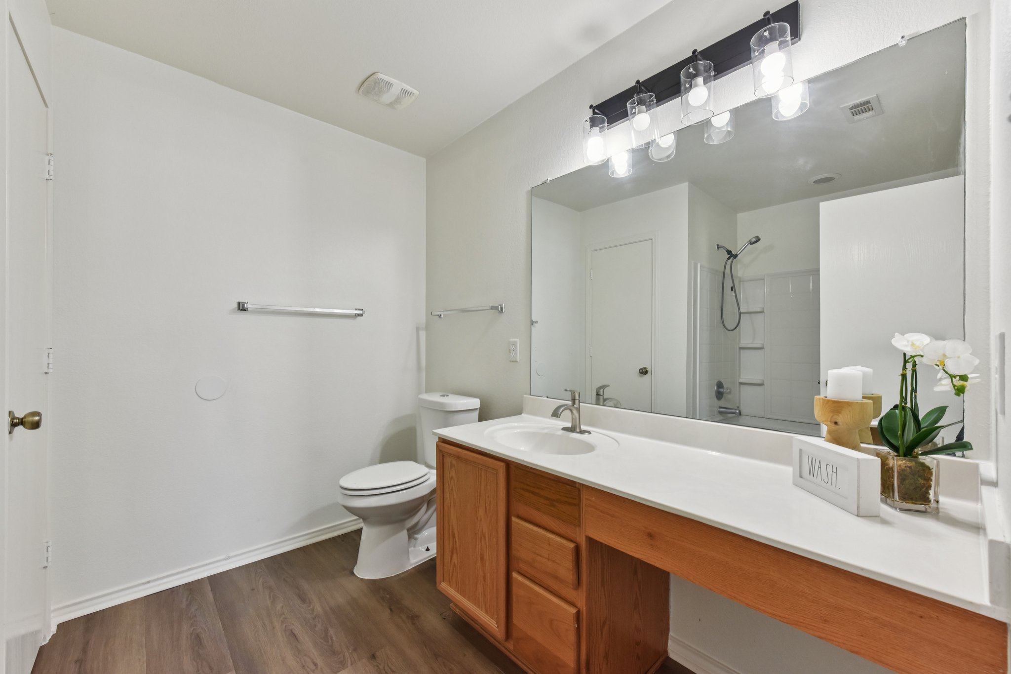 101 Bandara Woods Boulevard Elgin, TX 78621 - Photo 25 of 30 Full bath featuring vanity, dark wood-style flooring, and tub / shower combination