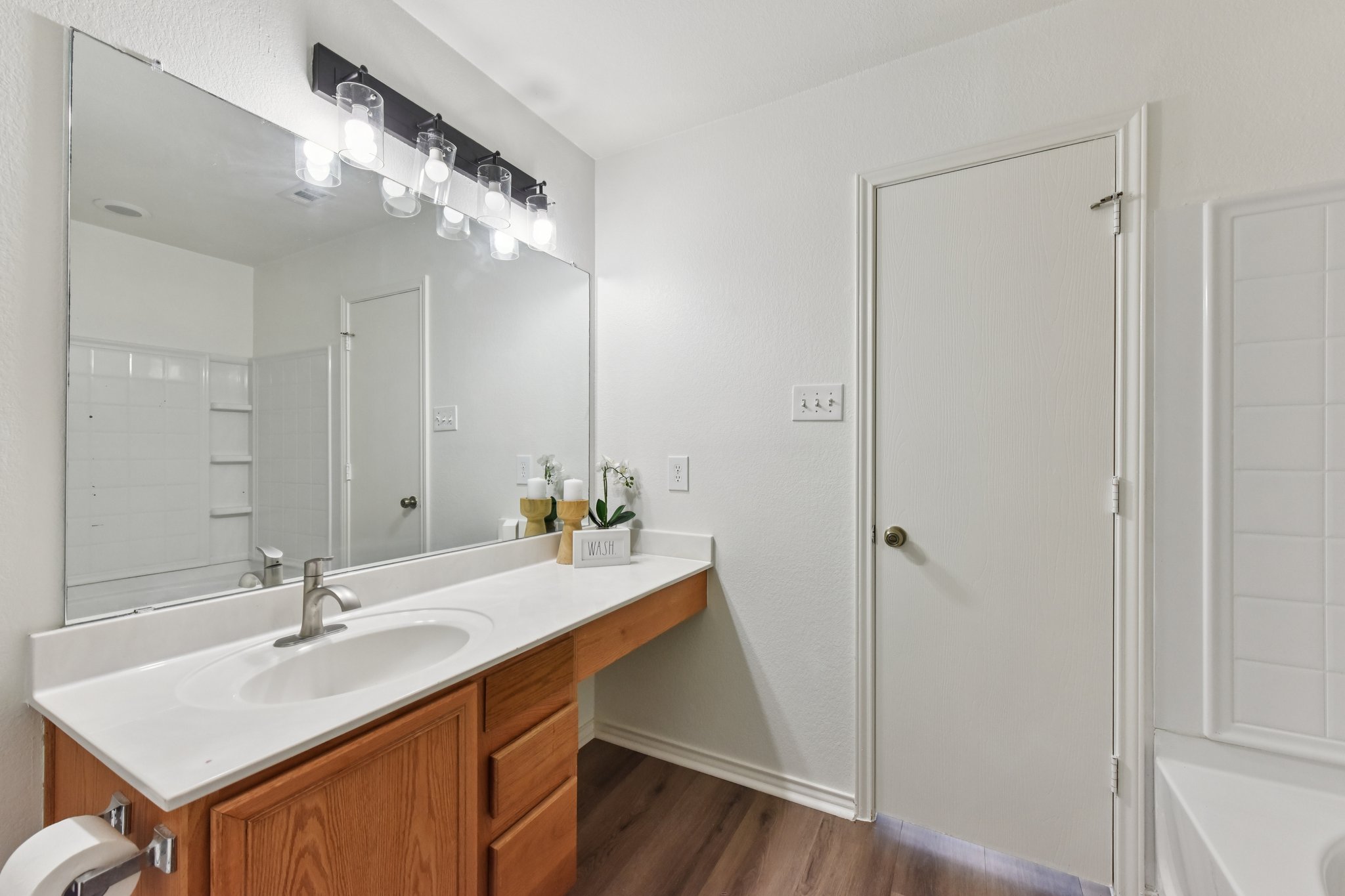 101 Bandara Woods Boulevard Elgin, TX 78621 - Photo 26 of 30 Full bath featuring vanity, a bathtub, and dark wood finished floors