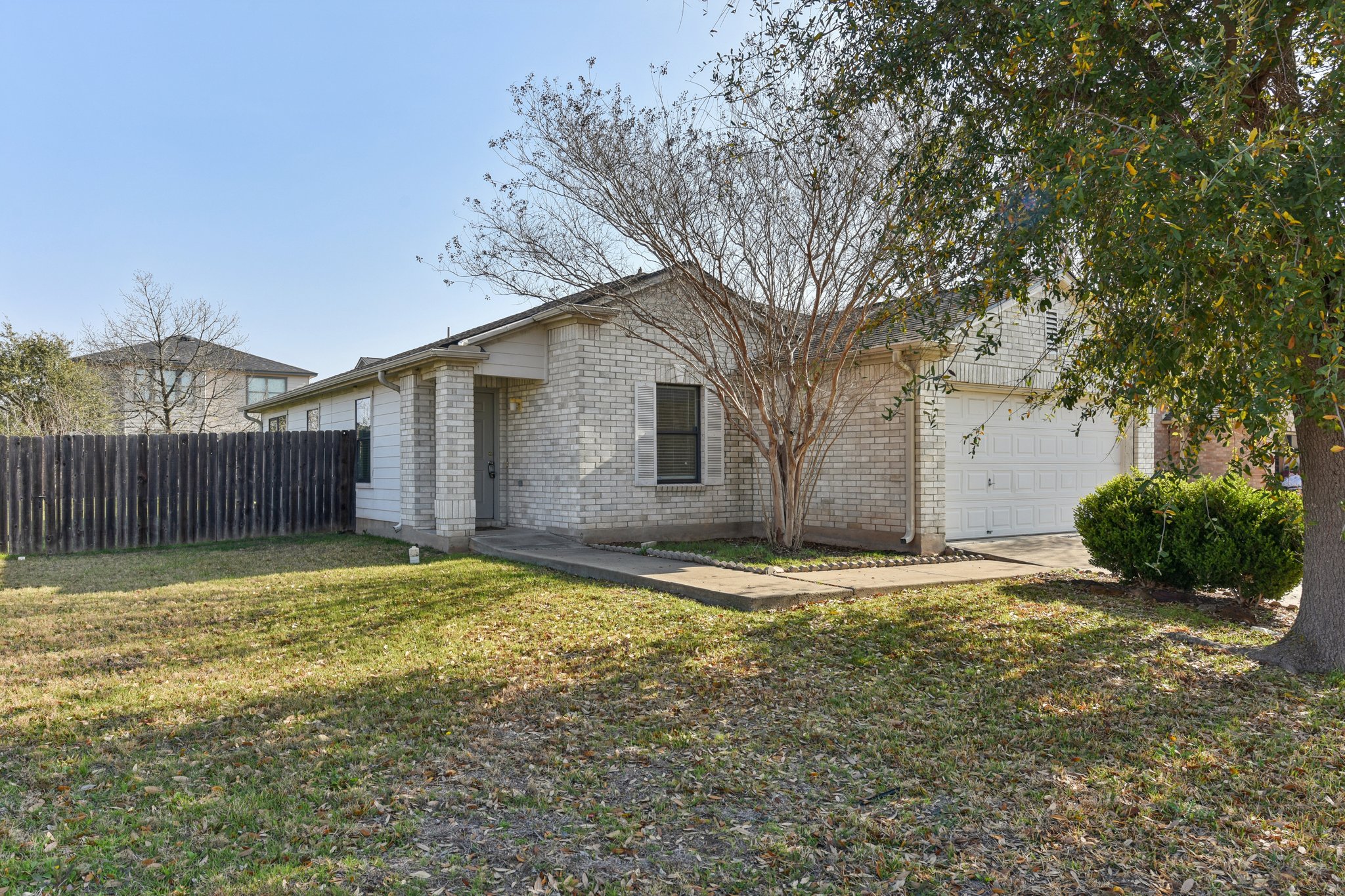 101 Bandara Woods Boulevard Elgin, TX 78621 - Photo 3 of 30 View of front of home featuring brick siding and a garage