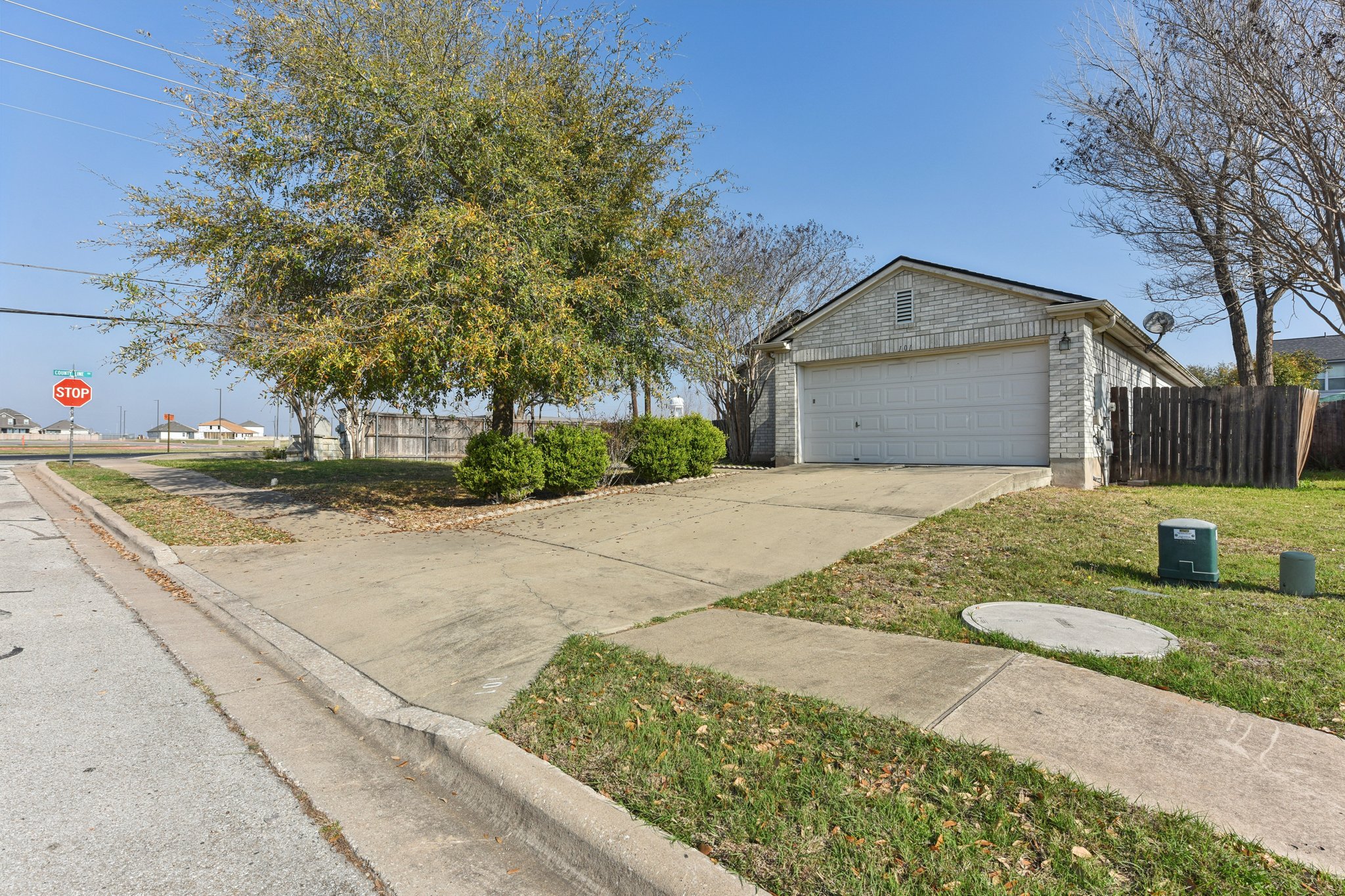101 Bandara Woods Boulevard Elgin, TX 78621 - Photo 6 of 30 View of front of home with concrete driveway, brick siding, and an attached garage