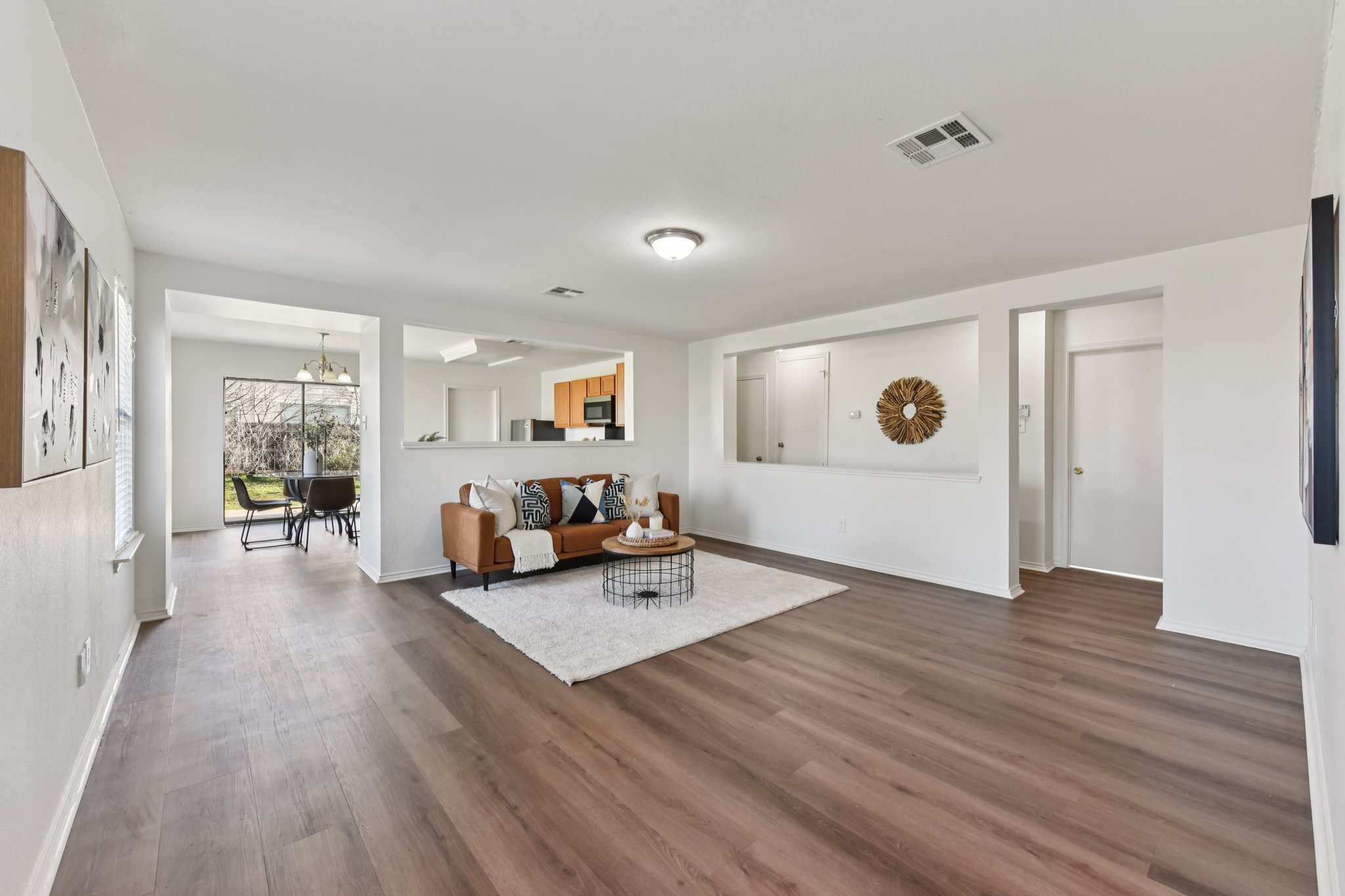 101 Bandara Woods Boulevard Elgin, TX 78621 - Photo 7 of 30 Living room with dark wood finished floors and hanging lights