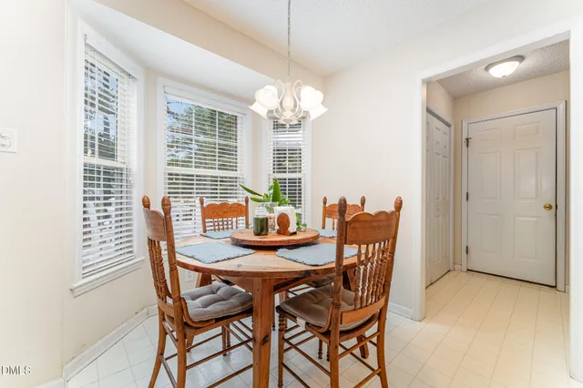 a view of a dining room with furniture and window