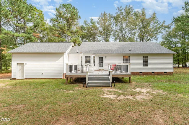 a front view of a house with a garden and deck