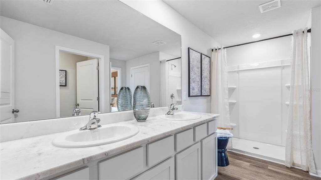 3322 Bitterroot Lane Lakewood Ranch, FL 34211 - Photo 18 of 50 a bathroom with a double vanity sink mirror and double