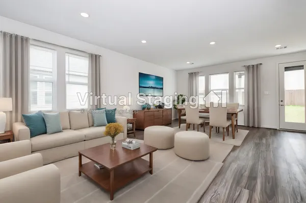 a living room with furniture potted plant and a large window