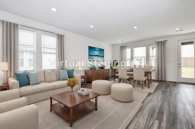 a living room with furniture potted plant and a large window