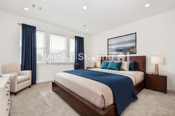 a spacious bedroom with a bed couch and a large window