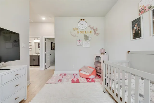 a bedroom with furniture and a flat screen tv