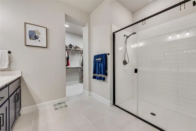 a bathroom with a shower and a sink
