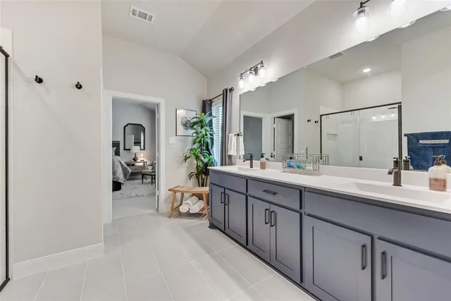 a spacious bathroom with a double vanity sink and a mirror