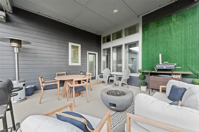 a view of a patio with couches chairs and potted plants