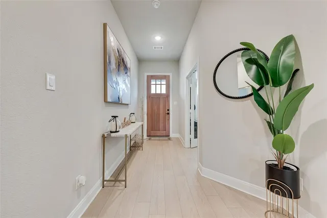 a view of a hallway with paintings on the wall