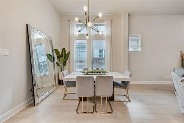 a view of a dining room with furniture and a chandelier