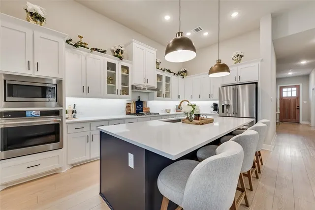 a kitchen with a table chairs stove and microwave