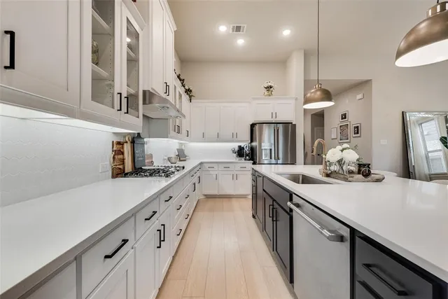 a kitchen with cabinets a sink and appliances