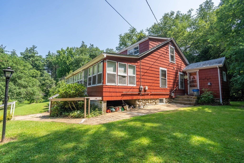607 Podunk Road East Brookfield, MA 01515 - Photo 2 of 42 a backyard of a house with table and chairs