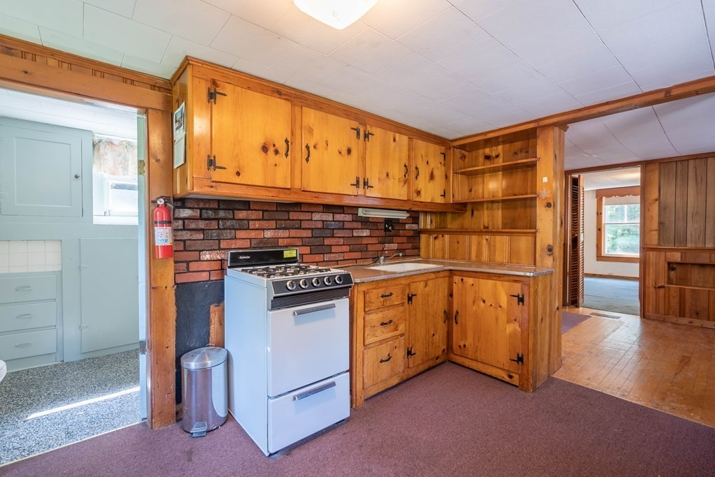 607 Podunk Road East Brookfield, MA 01515 - Photo 5 of 42 a kitchen with stainless steel appliances granite countertop a stove and a refrigerator