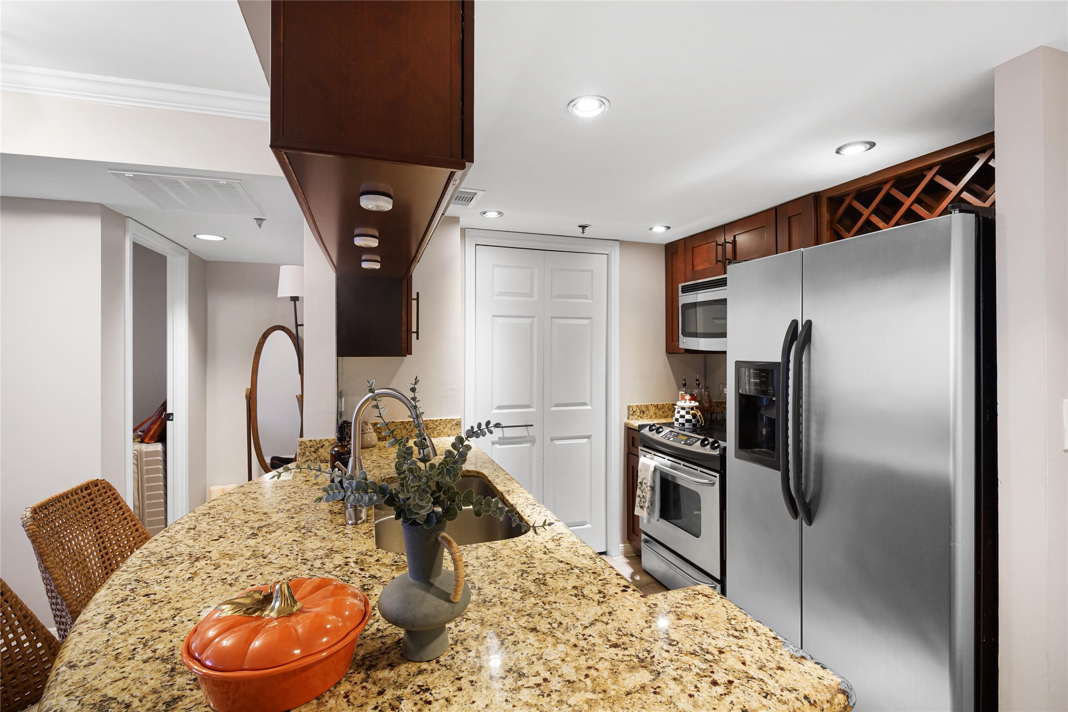 3525 Sage Road, Unit 1612 Houston, TX 77056 - Photo 3 of 8 a large kitchen with a refrigerator and a stove top oven