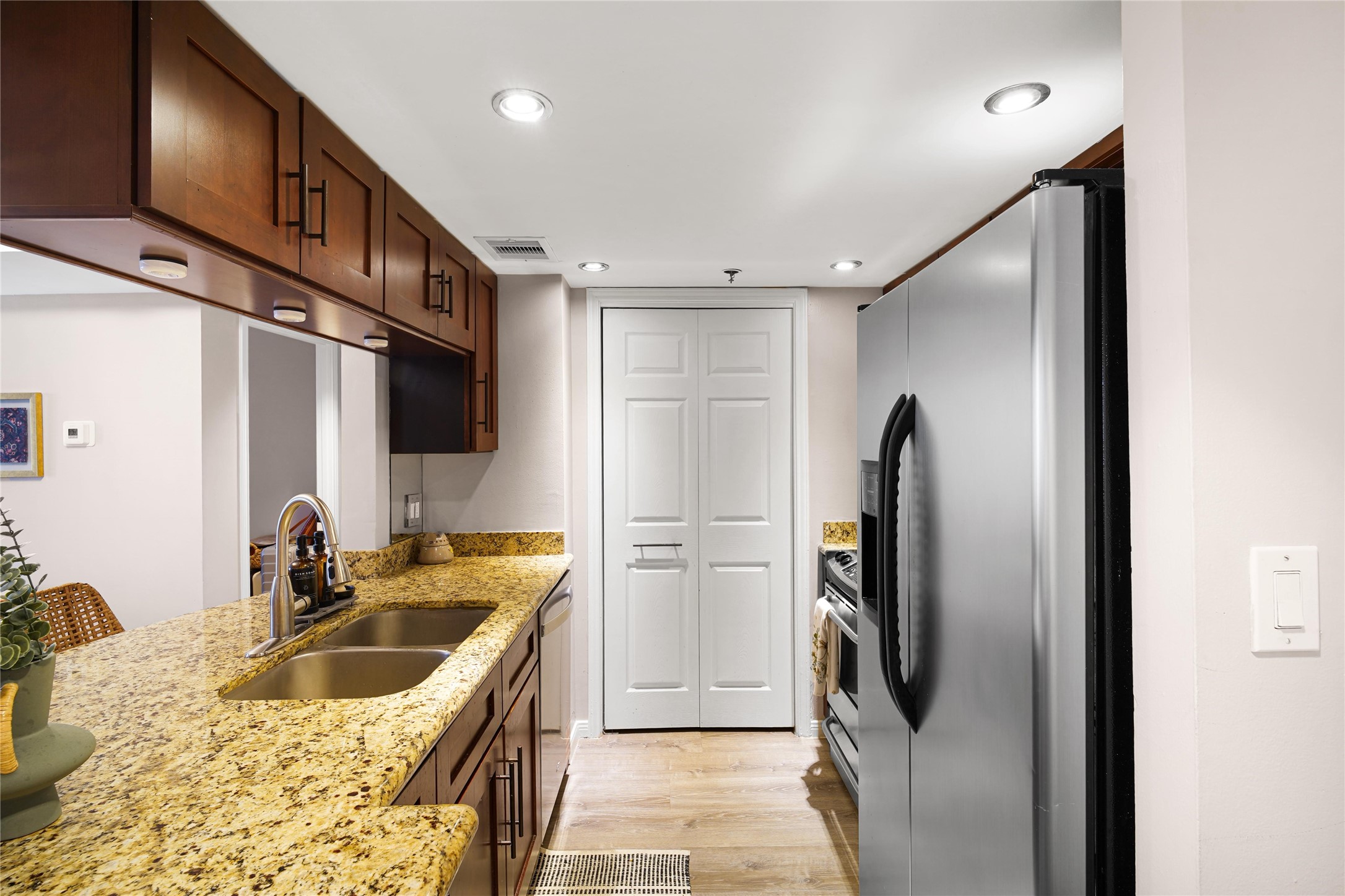 3525 Sage Road, Unit 1612 Houston, TX 77056 - Photo 4 of 8 a kitchen with refrigerator cabinets and a sink