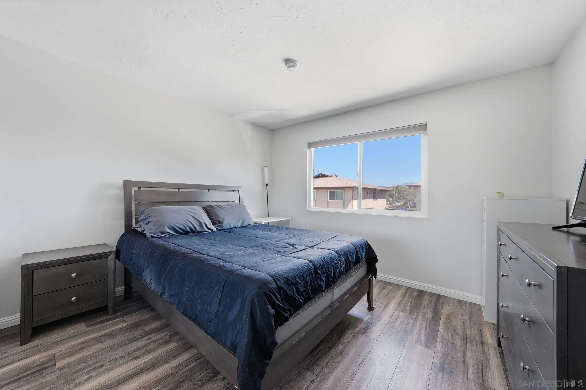 9926 Mission Vega Road, Unit 4 Santee, CA 92071 - Photo 19 of 30 a bedroom with a bed and a window