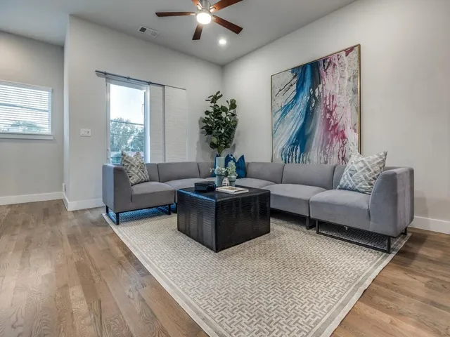 a living room with furniture and a large window