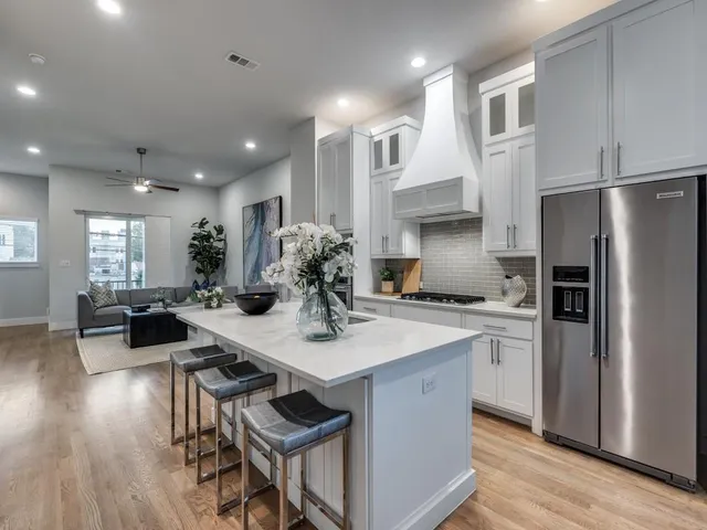 a kitchen with refrigerator and chairs