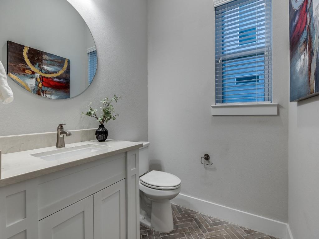 1129 Manderly Court Dallas, TX 75204 - Photo 18 of 33 Half bath featuring vanity and a textured wall