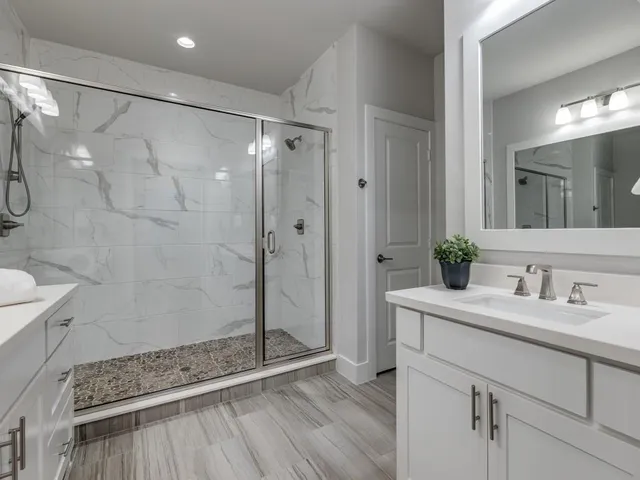 a bathroom with a shower sink and mirror