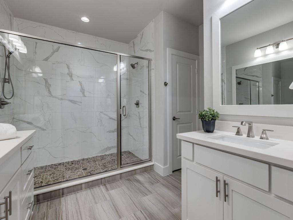 1129 Manderly Court Dallas, TX 75204 - Photo 20 of 33 Full bathroom featuring vanity and a marble finish shower