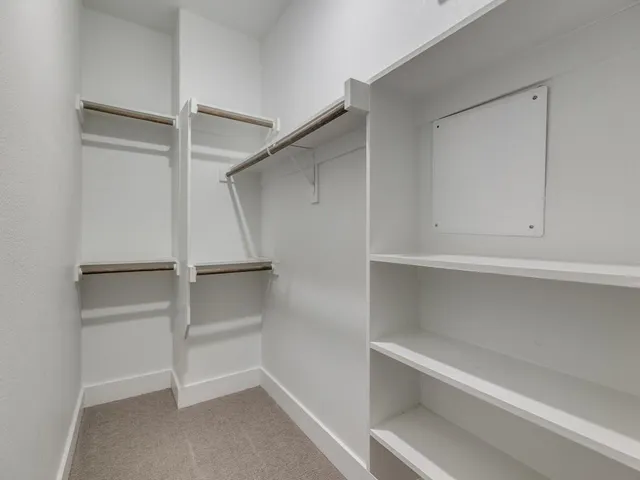a view of an empty walk in closet