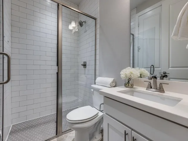 a bathroom with a sink toilet and shower
