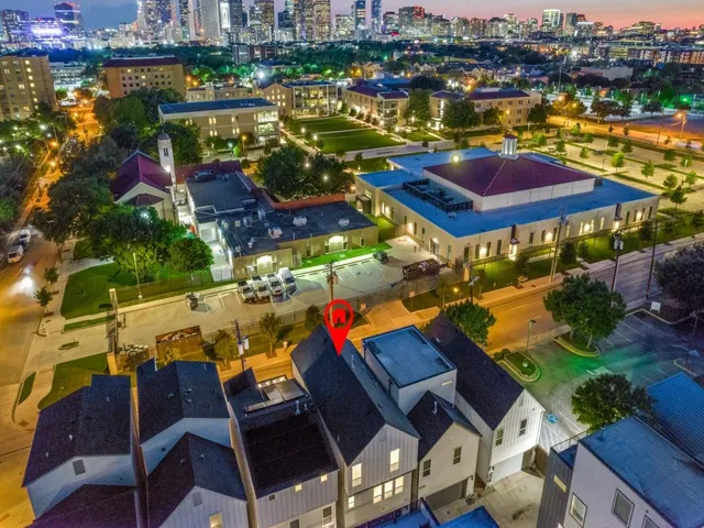 an aerial view of a houses with a swimming pool