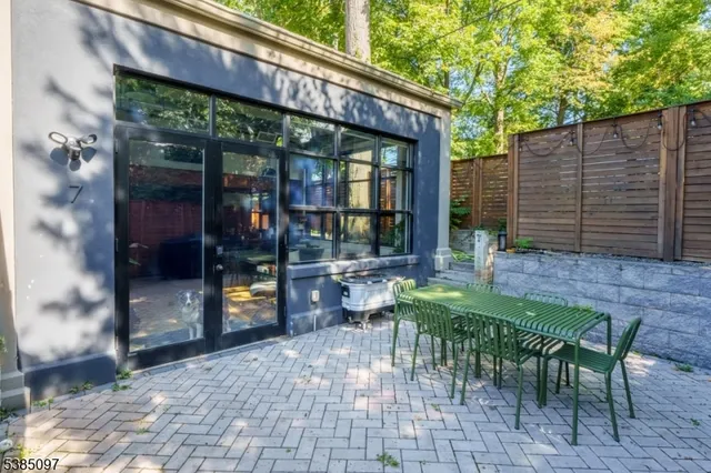 a view of a patio with table and chairs and potted plants