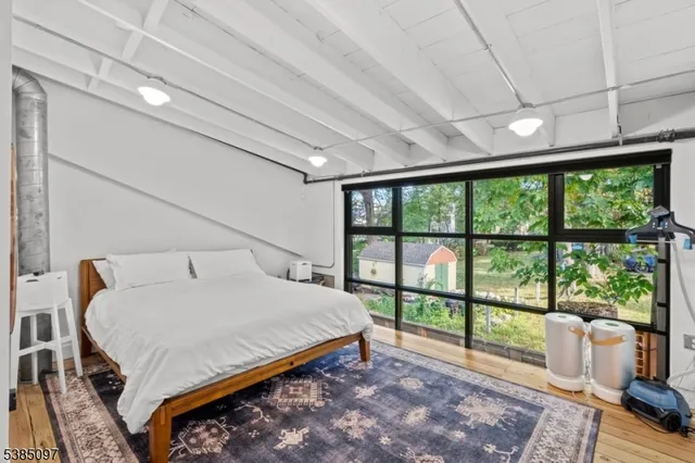 a bedroom with a large bed and a large window