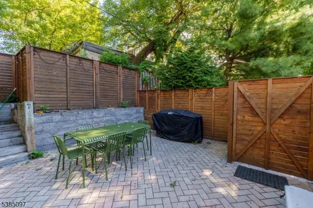 a view of house with backyard and furniture