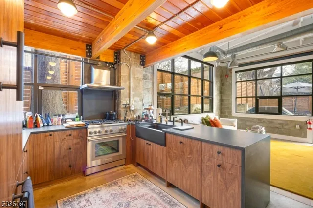 a kitchen with a sink stove and cabinets