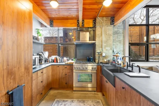 a kitchen with stainless steel appliances a sink and cabinets