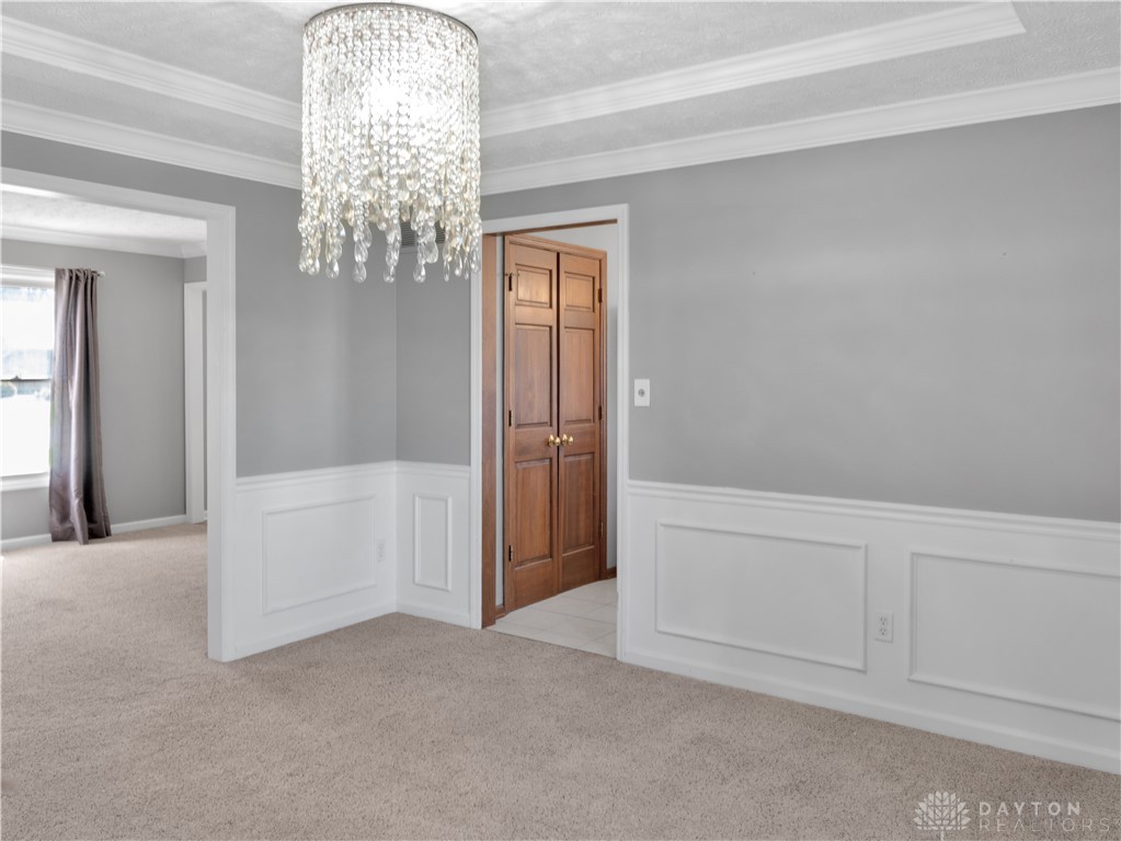 25 Callaway Springboro, OH 45066 - Photo 23 of 51 This inviting space features elegant crown molding and soft carpeting, perfect for comfortable living.