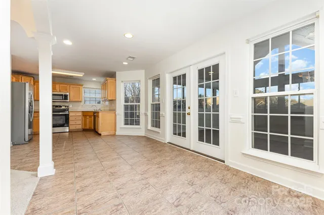 a view of a living room with furniture and windows