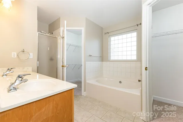 a bathroom with a tub sink and mirror