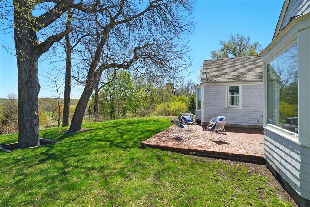 181 Grove Street Cambridge, MA 02138 - Photo 18 of 22 a view of a backyard with table and chairs and a large tree