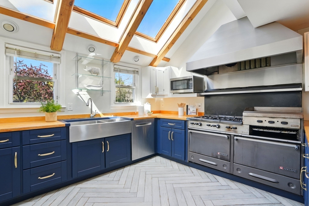 181 Grove Street Cambridge, MA 02138 - Photo 5 of 22 a kitchen with stainless steel appliances granite countertop a stove and a sink